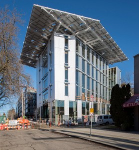 The Bullitt Center, here still being finished, has a 242-kW solar system on its roof, manufactured by HatiCon Solar.